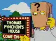 Cartoon frame showing a man with a paper bag over his head talking into a mobile phone. The bag has a large question mark printed on it and the man stands in front of a large illuminated sign in block letters which says 'THOMAS PYNCHON'S HOUSE – COME ON IN'