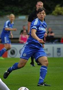 A woman in a blue football kit
