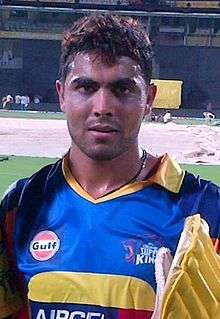 Ravindra Jadeja, who is seen wearing a yellow jersey and carrying his batting pads.