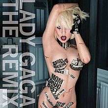 Lady Gaga naked with her right hand above her head and wearing a black glove on her left hand. Parts of her body are covered with thin stripes of newspaper.