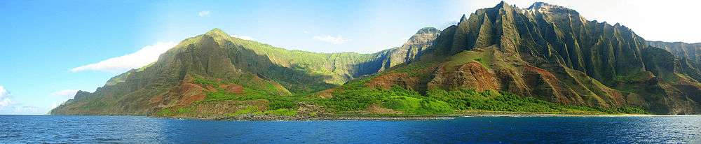 view of the Nā Pali coastline from the ocean. It is part of the Nā Pali Coast State Park which encompasses 6,175 acres (20 km2) of land and is located on the northwest side of Kauaʻii.