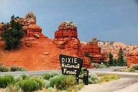 A photo of Scenic Byway 12 and a Dixie National Forest sign in Red Canyon