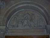 Carved stone tympanum showing Richard Arkwright apparently making calculations alongside experimental models of the water frame