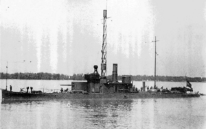 a black and white photograph of a low profile vessel on a river