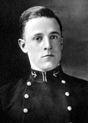 Head and shoulders of a young white man with neatly combed hair wearing a dark jacket with two columns of buttons down the chest and an anchor emblem on each side of the upright collar.