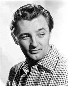 Black and white promotional headshot of Robert Mitchum facing right and looking left