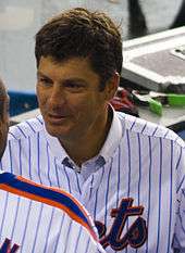 Robin Ventura, wearing a blue pinstripe jersey with the words METS partially cut off, converses with a fellow player