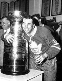 Ron Stewart as a Toronto Maple Leafs team member, posing with the Stanley Cup.