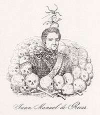 Engraving depicting a man wearing an ornate military uniform waist-deep in a pile of human skulls and bones with a disembodied hand holding snakes above his head
