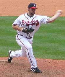 Royce Ring throwing a pitch, about to release the ball, playing for the Atlanta Braves.