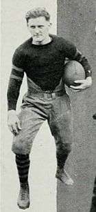 Rupert Smith in uniform, posing with a football