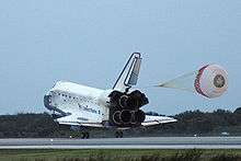 Space Shuttle Discovery landing, with its drogue parachute deployed and its rudder split to act as an air brake