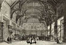 19th-century stage set showing a grand English Tudor interior