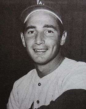 A black-and-white picture of Sandy Koufax smiling in a Los Angeles Dodgers uniform.