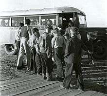 Children boarding a school bus in 1940.