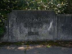 The bridge name ("Schmitz Park Bridge") and year ("1936") completed engraved on in concrete