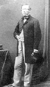 Full-length photograph of a smartly dressed middle-aged man