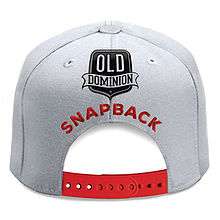 A white snapback hat with red strap is centered on the white background with the title colored in red and the band's logo above it.