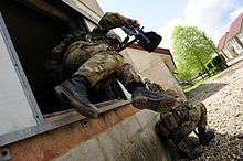 British soldier jumping out of a window on exercise