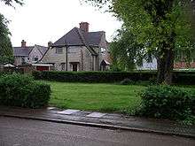 Larkin's parents' former Radford council house overlooks a small spinney, once their garden. The spinney is on the corner of two roads. It is a lawn, maintained by the Coventry City Council groundsmen, with some mature trees and bushes around the perimeter as seen in 2008