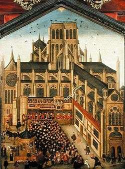 A colourful painting of a sermon being preached to hundreds of people from a wooden pulpit in the grounds of the old cathedral. The perspective of the image is wrong, making the people look huge by comparison to the building.