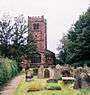 A stone Gothic church with a battlemented tower