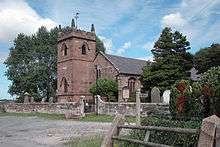 A stone Gothic church with a pinnacled and battlemented tower
