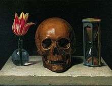 Symbols of death in a painting: it shows a flower, a skull and an hourglass