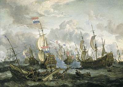 English and Dutch sailing ships clash on a stormy sea; a wreck of a sinking vessel can be seen in the foreground, whilst the sky is full busy white clouds.