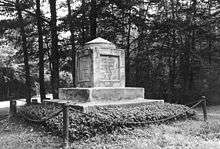 A black and white picture of a cube monument topped by a pyramid, both of stone, containing Sumner's remains