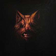 A painting of a wolf's face with its teeth bared