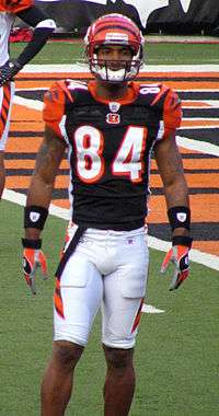 A dark-skinned man wearing American football attire