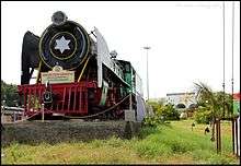 A vintage steam locomotive at the entrance of Tiruchirappalli Junction