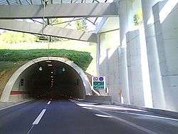Tunnel portal and a structure supporting a cover ahead of the portal