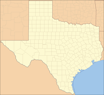 A map of the state of Texas with a red dot on the northeast corner