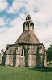 A photograph of the kitchen building at Glastonbury Abbey; illustrating an externally square building with an octagonal internal layout, which is how Leicester Abbey's kitchens were laid-out