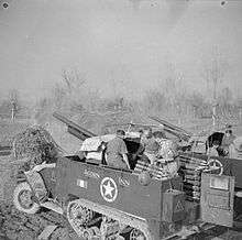 Two British M3 GMCs used for indirect fire in a barren field in Northern Italy. The M3 in the foreground was nicknamed "Acorn Inn" by its crew.