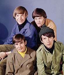 A photograph of each of the Monkees: Peter Tork, Micky Dolenz, Michael Nesmith and Davy Jones