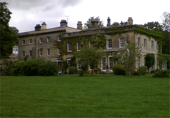 A view of the Thedden Grange manor from the south side, showing the gardens and rear side of the manor