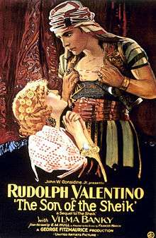 Film poster showing a stylised image of Rudolph Valentino, dressed in traditional Arab robes. He stands above a seated blonde woman; she looks up at him, while he is staring at her. The film's name and other details are shown at the bottom.