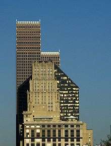 Three skyscrapers visually overlap each other. The simple, rectangular tiers of JPMorgan Chase Building contrast with the five-sided tower of the Pennzoil building and the stepped rows of spires of the Bank of America building.