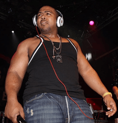 An African-American man is wearing headphones while performing