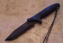 A black tanto bladed fighting knife.