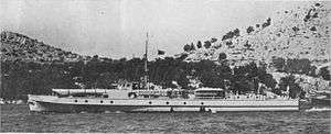 a black and white photograph of a ship underway