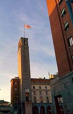 Civic Tower in the afternoon. On the roof, the flag of the city of Varese