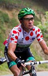 Thomas Voeckler wearing a white cycling jersey with red polka dots.