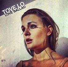 Artwork for "Love Ballad". A woman with brown hair and wearing fake eyelashes is looking forward. Above her image, the words "Tove Lo" are written with white letters, as well as the words "Love Ballad", which are written with black letters.