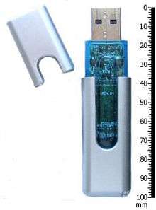 Thumb drive and its cap, next to a 100-mm ruler