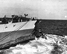 USS Washington at sea with collision damage