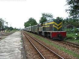 A train stopped at a station on the North–South Railway, Vietnam